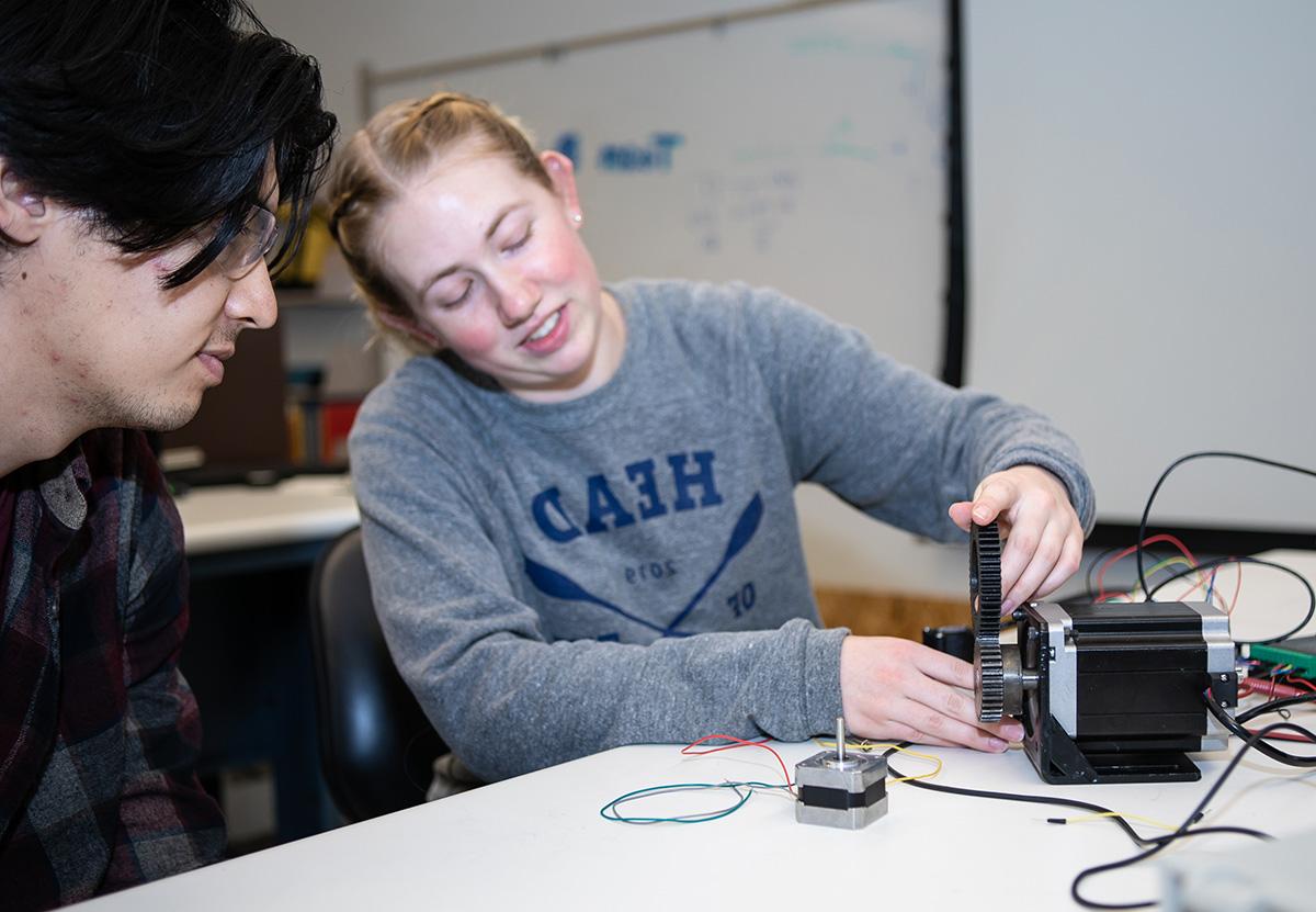 Engineering students work on a tabletop project